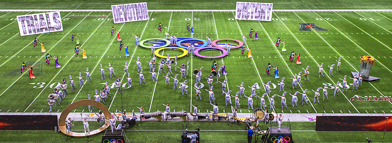 The final moment of Mineola's show "Carry the Torch" has the band making a curved path from the torch to the gold medal, which they will attempt to earn in their finals performance.